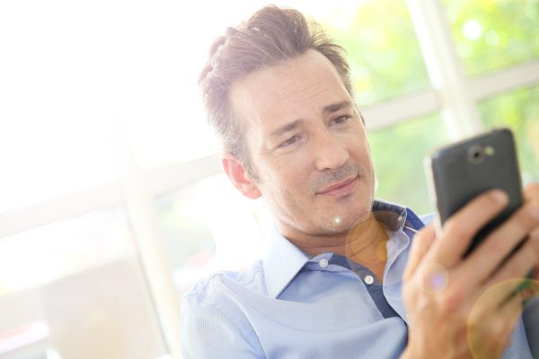 portrait-of-middle-aged-man-using-smartphone
